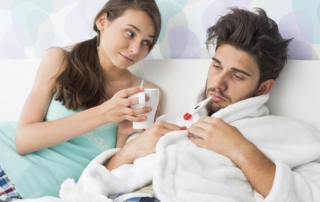 Young woman giving coffee mug to man