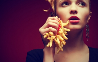 Woman-holding-French-fries