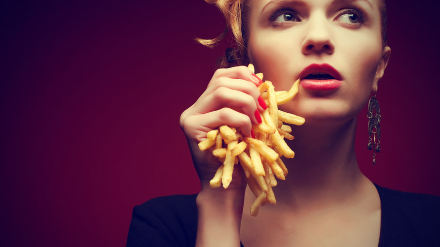 Woman-holding-French-fries